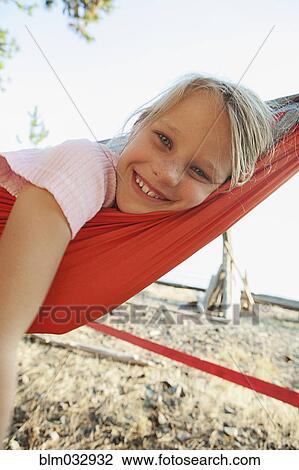 Close up of Caucasian girl smiling in hammock View Large Photo Image Stock Image - Close up of Caucasian girl smiling in hammock. Fotosearch