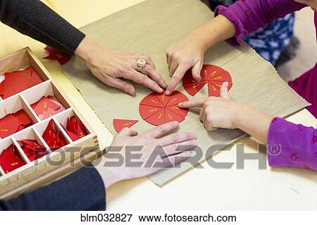Close up of Caucasian Montessori teacher and student solving puzzle View Large Photo Image Stock Photo - Close up of Caucasian Montessori teacher and student solving puzzle. Fotosearch