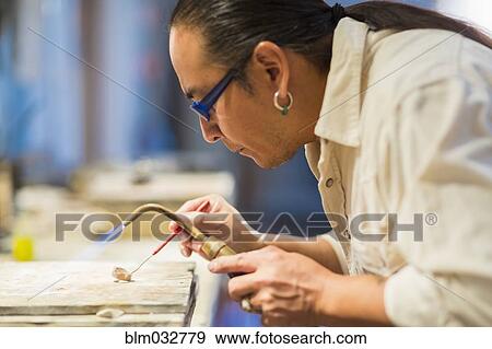 Close up of Native American jeweler using blowtorch in studio View Large Photo Image Stock Photo - Close up of Native American jeweler using blowtorch in studio. Fotosearch