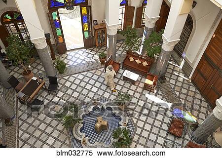 Stock Photography - High angle view of Caucasian man in ornate lobby. Fotosearch
