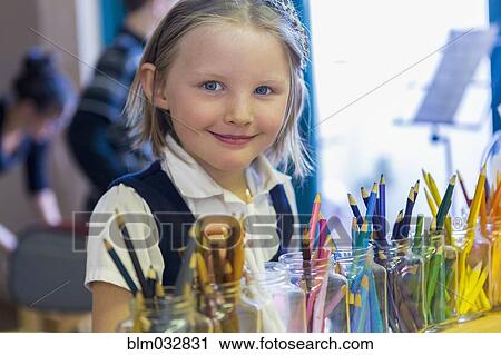 Mixed race girl smiling near multicolor pencils in classroom View Large Photo Image Stock Image - Mixed race girl smiling near multicolor pencils in classroom. Fotosearch