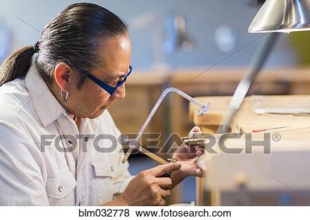 Native American jeweler working in studio View Large Photo Image Stock Photo - Native American jeweler working in studio. Fotosearch