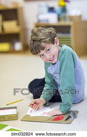 Smiling boy drawing in classroom View Large Photo Image Picture - Smiling boy drawing in classroom. Fotosearch