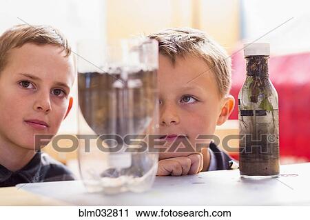 Students examining bottles in classroom View Large Photo Image Stock Image - Students examining bottles in classroom. Fotosearch