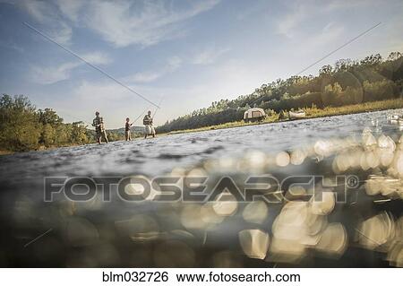 Three generations of Caucasian men fishing in river View Large Photo Image Stock Photograph - Three generations of Caucasian men fishing in river. Fotosearch