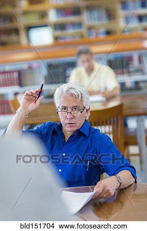 Adult student raising his hand in class View Large Photo Image Picture - Adult student raising his hand in class. Fotosearch