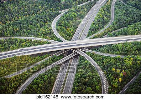 Stock Photography - "Aerial view of intersecting highways near trees, London, England". Fotosearch