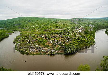 Aerial view of village near bend in river View Large Photo Image Stock Photo - Aerial view of village near bend in river. Fotosearch