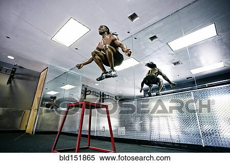 Stock Photography - African American man working out in gym. Fotosearch