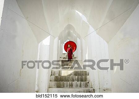 Stock Photography - "Asian monk under umbrella on temple staircase, Mingun, Mandala, Myanmar". Fotosearch