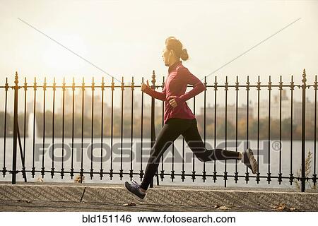 Asian woman running on waterfront path View Large Photo Image Stock Photograph - Asian woman running on waterfront path. Fotosearch
