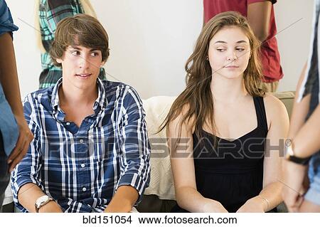 Awkward curious teenage couple at party View Large Photo Image Picture - Awkward curious teenage couple at party. Fotosearch