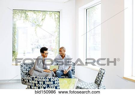 Black business people using digital tablet in office lobby View Large Photo Image Stock Photograph - Black business people using digital tablet in office lobby. Fotosearch