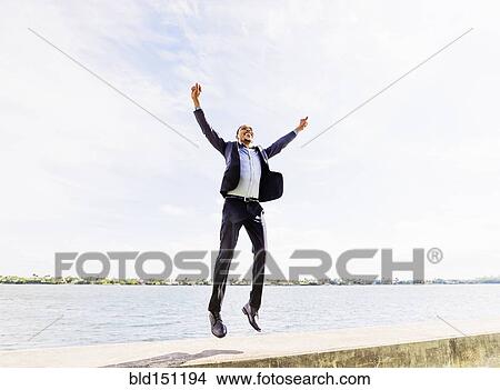 Black businessman jumping for joy outdoors View Large Photo Image Picture - Black businessman jumping for joy outdoors. Fotosearch