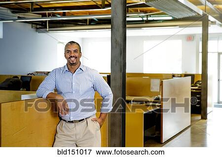 Stock Photo - Black businessman smiling in office. Fotosearch
