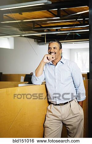 Black businessman smiling in office View Large Photo Image Stock Photograph - Black businessman smiling in office. Fotosearch