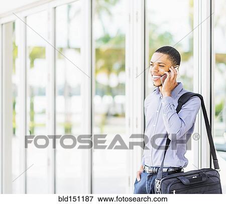 Black businessman talking on cell phone outdoors View Large Photo Image Stock Photo - Black businessman talking on cell phone outdoors. Fotosearch