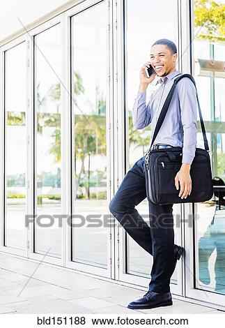 Black businessman talking on cell phone outdoors View Large Photo Image Stock Photo - Black businessman talking on cell phone outdoors. Fotosearch