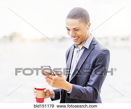 Black businessman using cell phone outdoors View Large Photo Image Stock Photo - Black businessman using cell phone outdoors. Fotosearch