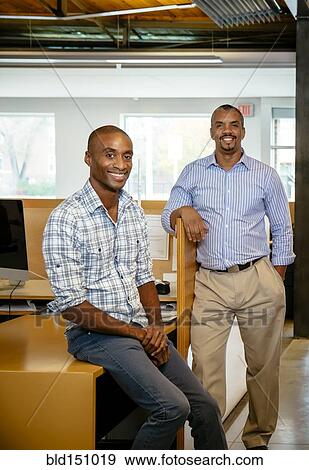 Black businessmen smiling in office View Large Photo Image Stock Photo - Black businessmen smiling in office. Fotosearch