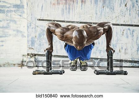 Black man doing push ups in warehouse View Large Photo Image Stock Image - Black man doing push ups in warehouse. Fotosearch