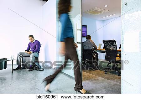 Blurred view of businesswoman walking in office View Large Photo Image Stock Image - Blurred view of businesswoman walking in office. Fotosearch