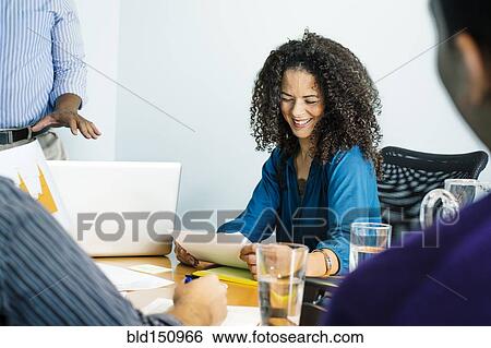 Stock Photograph - Business people talking in office meeting. Fotosearch