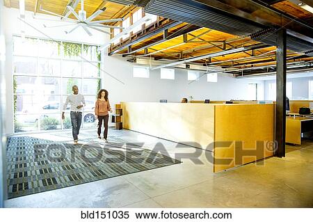 Stock Photography - Business people walking in office lobby. Fotosearch