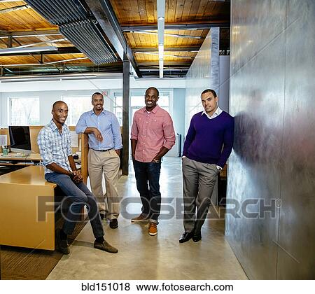 Stock Photo - Businessmen smiling in office. Fotosearch