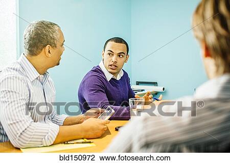 Businessmen talking in office meeting View Large Photo Image Stock Image - Businessmen talking in office meeting. Fotosearch