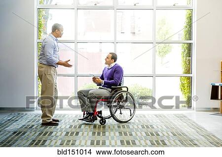 Picture - Businessmen talking in office. Fotosearch