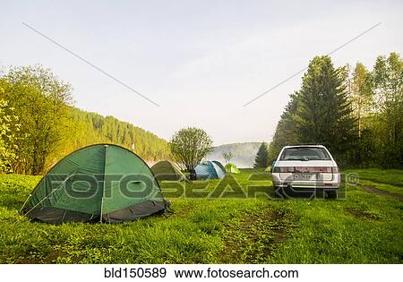 Car and tents at campsite in field View Large Photo Image Stock Photo - Car and tents at campsite in field. Fotosearch