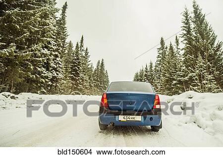 Picture - Car driving on snowy remote road. Fotosearch