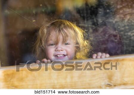 Caucasian baby smiling and looking out window View Large Photo Image Picture - Caucasian baby smiling and looking out window. Fotosearch