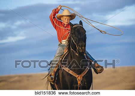 Caucasian boy on horse throwing lasso View Large Photo Image Stock Photograph - Caucasian boy on horse throwing lasso. Fotosearch