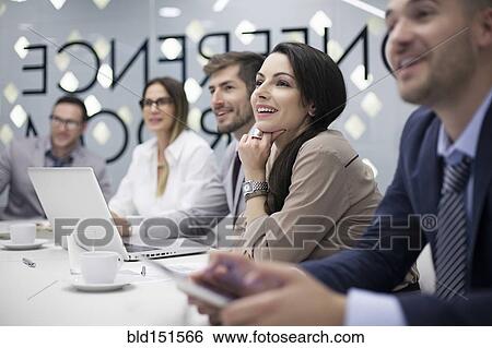 Stock Photograph - Caucasian business people listening in office meeting. Fotosearch