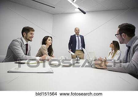 Picture - Caucasian business people talking in office meeting. Fotosearch