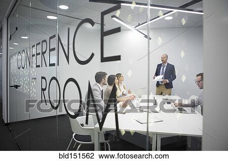 Stock Image - Caucasian business people talking in office meeting. Fotosearch