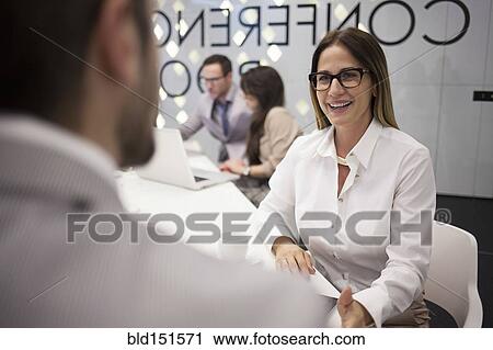 Caucasian business people talking in office meeting View Large Photo Image Stock Image - Caucasian business people talking in office meeting. Fotosearch