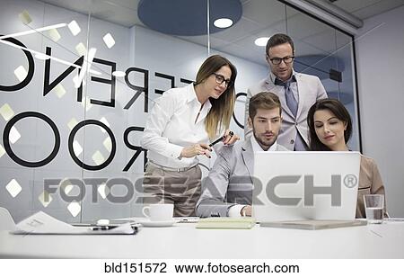 Caucasian business people using laptop in office meeting View Large Photo Image Stock Image - Caucasian business people using laptop in office meeting. Fotosearch