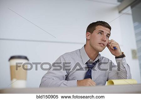 Caucasian businessman sitting in office View Large Photo Image Stock Photography - Caucasian businessman sitting in office. Fotosearch