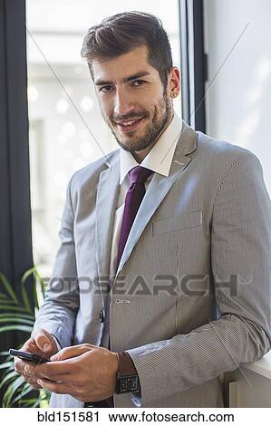 Stock Image - Caucasian businessman using cell phone. Fotosearch
