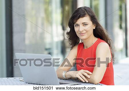 Caucasian businesswoman with laptop smiling outdoors View Large Photo Image Stock Image - Caucasian businesswoman with laptop smiling outdoors. Fotosearch