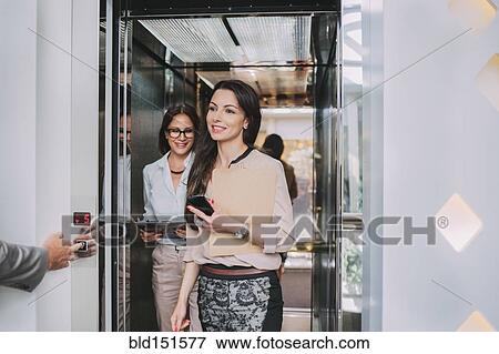 Caucasian businesswomen walking out of elevator View Large Photo Image Stock Photo - Caucasian businesswomen walking out of elevator. Fotosearch