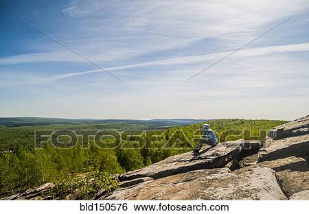 Caucasian climber sitting on rock formation View Large Photo Image Stock Photograph - Caucasian climber sitting on rock formation. Fotosearch