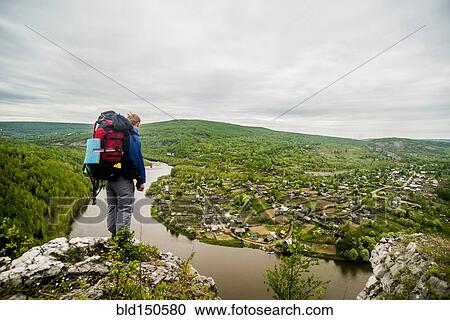 Caucasian hiker admiring scenic view of village View Large Photo Image Stock Image - Caucasian hiker admiring scenic view of village. Fotosearch