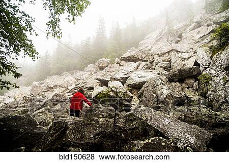 Caucasian hiker climbing rocky hillside View Large Photo Image Stock Photo - Caucasian hiker climbing rocky hillside. Fotosearch