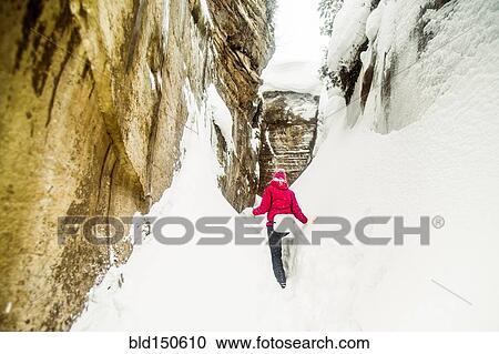 Caucasian hiker exploring snowy rock formations View Large Photo Image Stock Image - Caucasian hiker exploring snowy rock formations. Fotosearch