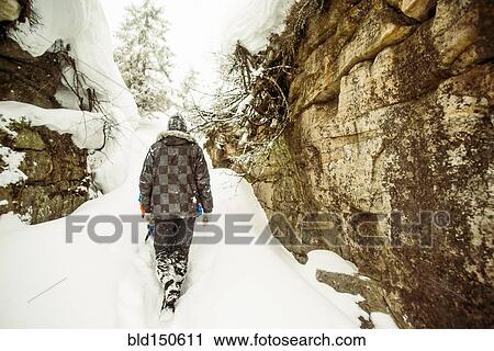 Caucasian hiker exploring snowy rock formations View Large Photo Image Stock Image - Caucasian hiker exploring snowy rock formations. Fotosearch