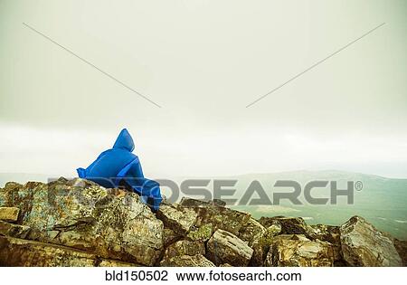 Caucasian hiker sitting on rocky hilltop View Large Photo Image Stock Image - Caucasian hiker sitting on rocky hilltop. Fotosearch